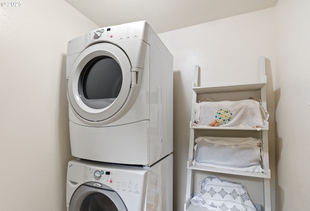 washroom featuring laundry area and stacked washer and dryer