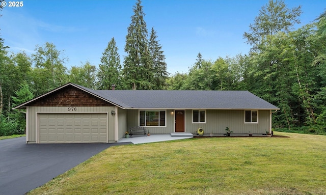 ranch-style home featuring a front lawn, driveway, and an attached garage