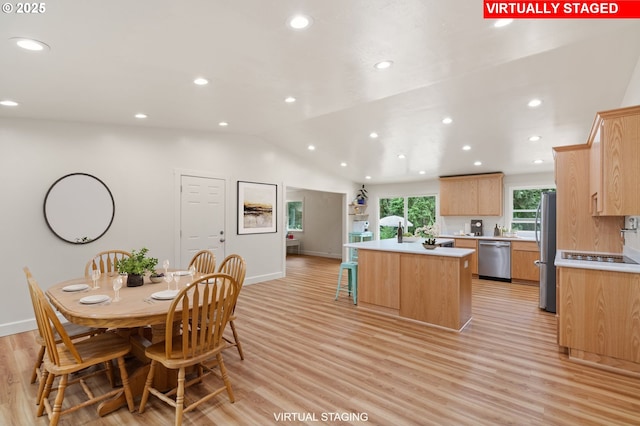 dining room with vaulted ceiling, light wood-style flooring, and recessed lighting