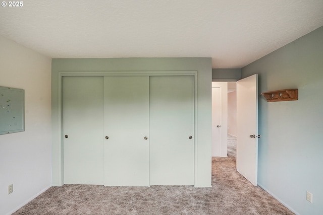 unfurnished bedroom featuring a closet and carpet flooring