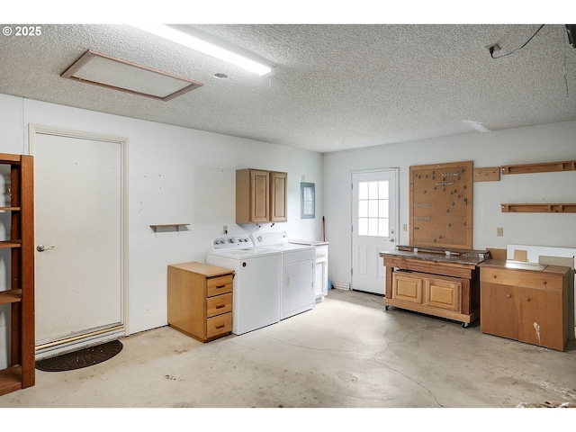laundry area featuring attic access, cabinet space, independent washer and dryer, and a textured ceiling