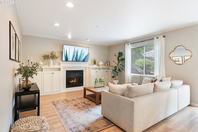 2233 NW Oxford St, Camas, WA 98607 - living area with light wood finished floors, ornamental molding, a glass covered fireplace, and recessed lighting
