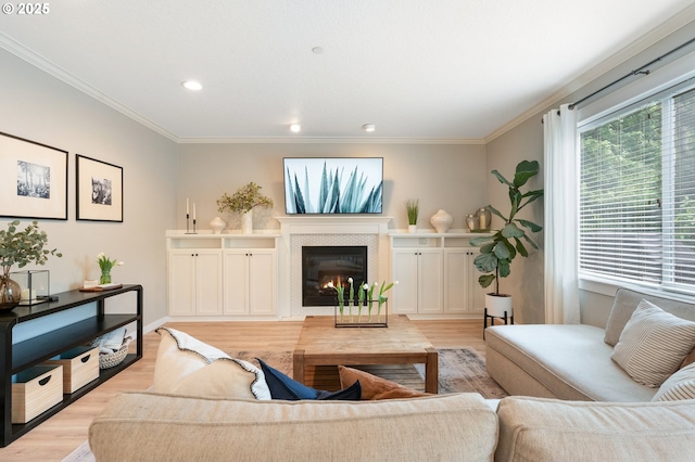 2233 NW Oxford St, Camas, WA 98607 - living room with light wood-style floors, crown molding, a glass covered fireplace, and recessed lighting