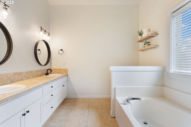 2233 NW Oxford St, Camas, WA 98607 - bathroom with double vanity, a garden tub, decorative backsplash, tile patterned flooring, and baseboards