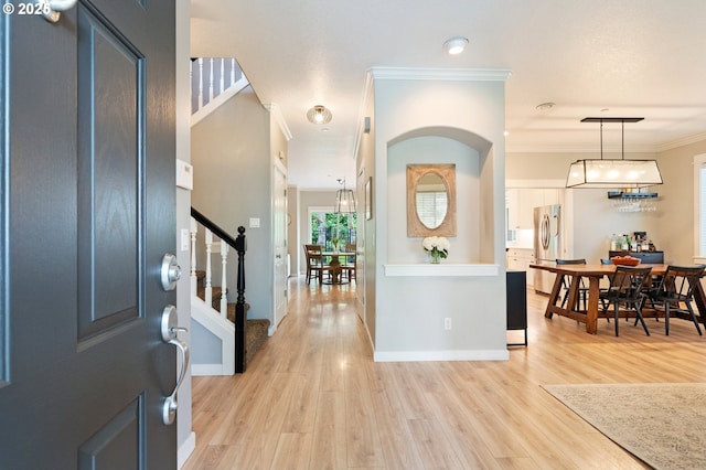 2233 NW Oxford St, Camas, WA 98607 - entryway featuring light wood-style floors, stairs, crown molding, and baseboards