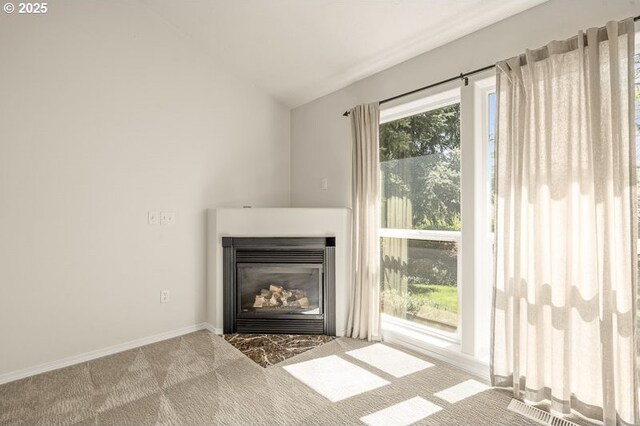366 Pintail Ave SE, Salem, OR 97306 - unfurnished living room featuring lofted ceiling, a glass covered fireplace, carpet floors, and baseboards