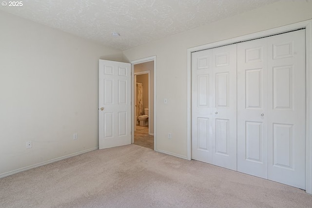 366 Pintail Ave SE, Salem, OR 97306 - unfurnished bedroom featuring a textured ceiling, baseboards, carpet floors, and a closet