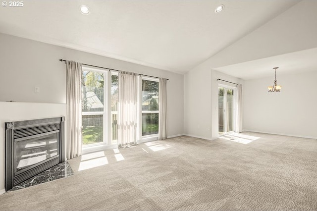 366 Pintail Ave SE, Salem, OR 97306 - unfurnished living room featuring vaulted ceiling, a glass covered fireplace, an inviting chandelier, carpet floors, and recessed lighting