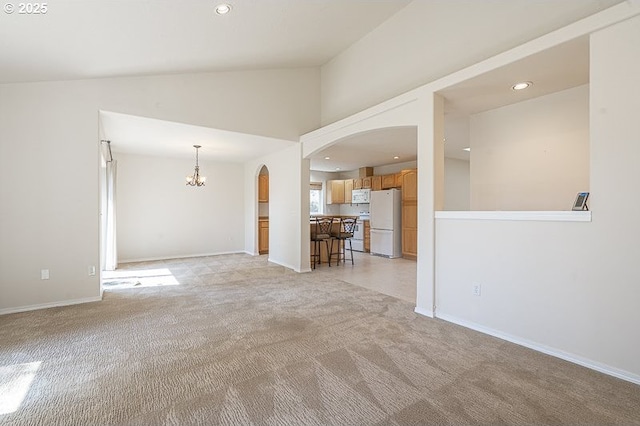 366 Pintail Ave SE, Salem, OR 97306 - unfurnished living room with recessed lighting, vaulted ceiling, arched walkways, a chandelier, and light colored carpet
