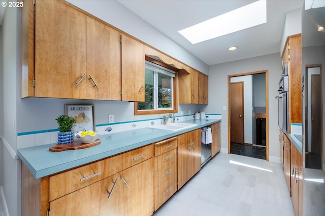 15 SW 95th Ave, Portland, OR 97225 - kitchen featuring dishwasher, a sink, a skylight, light countertops, and light flooring