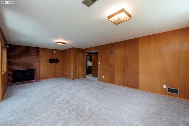 15 SW 95th Ave, Portland, OR 97225 - unfurnished living room featuring carpet flooring, a brick fireplace, and wood walls