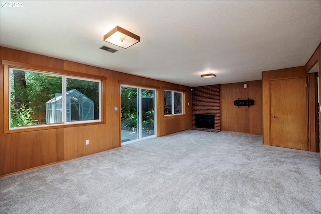 15 SW 95th Ave, Portland, OR 97225 - unfurnished living room featuring a fireplace, carpet floors, and wood walls