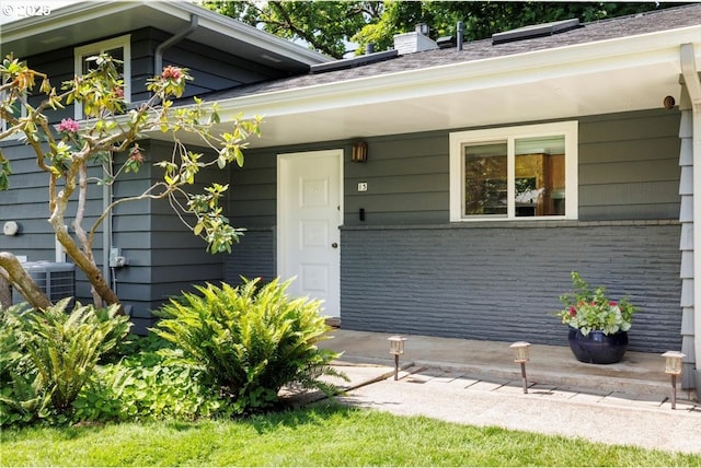 15 SW 95th Ave, Portland, OR 97225 - entrance to property featuring central AC unit, a porch, a chimney, and brick siding