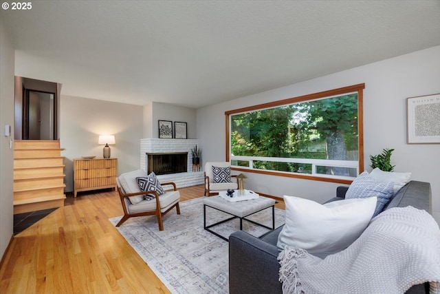 15 SW 95th Ave, Portland, OR 97225 - living room with wood finished floors, stairs, and a brick fireplace