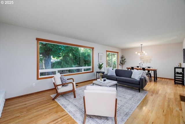 15 SW 95th Ave, Portland, OR 97225 - living area with a chandelier, light wood-type flooring, and baseboards