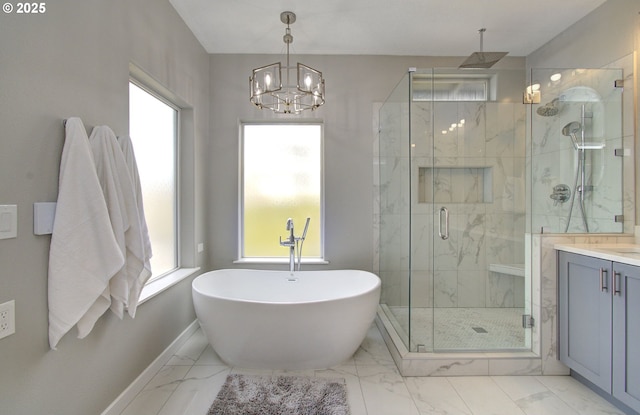 bathroom with vanity, baseboards, a freestanding bath, marble finish floor, and a marble finish shower