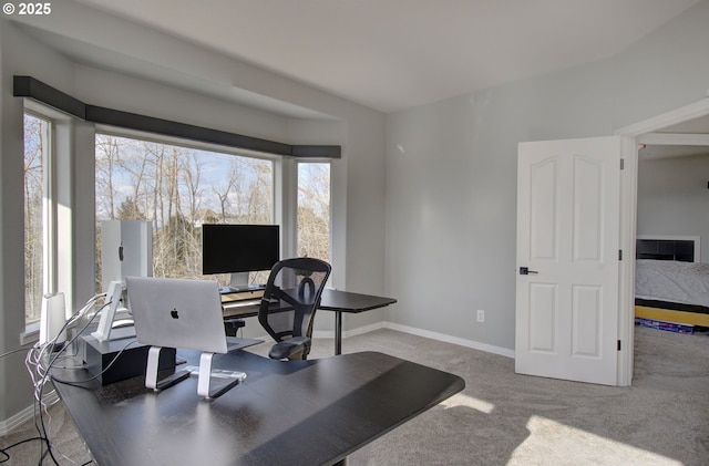 home office featuring light carpet and baseboards