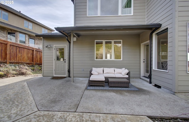 view of patio featuring fence and an outdoor hangout area