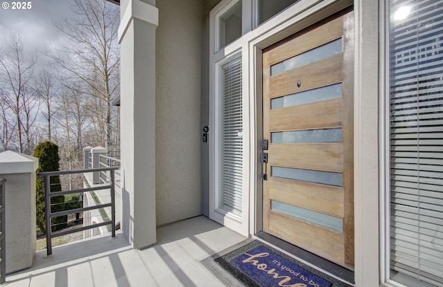 doorway to property with stucco siding