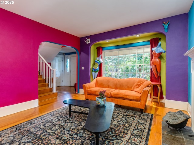 3843 SE 41st Ave SE, Portland, OR 97202 - living room featuring arched walkways, wood finished floors, and stairway
