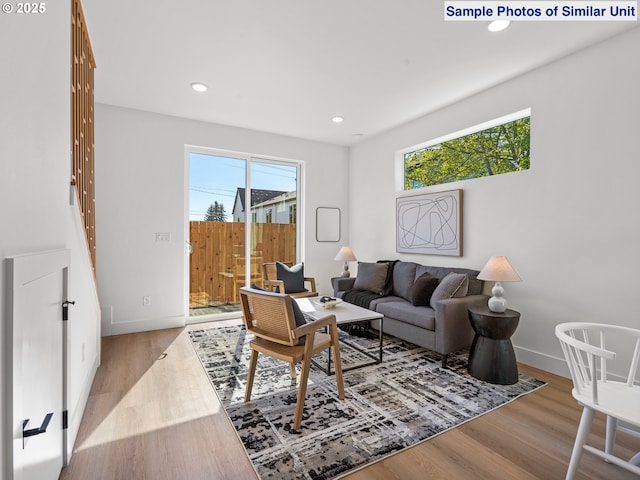 1218 SE Center St Unit 3, Portland, OR 97202 - living room featuring wood finished floors, baseboards, and recessed lighting
