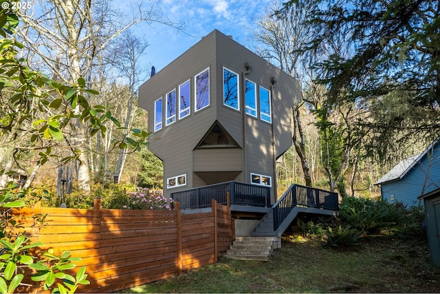 back of property with a wooden deck