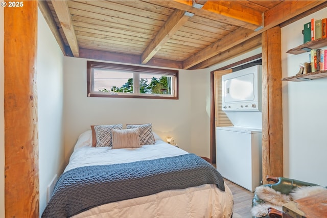 bedroom with stacked washer and dryer, light hardwood / wood-style flooring, wooden ceiling, and beamed ceiling