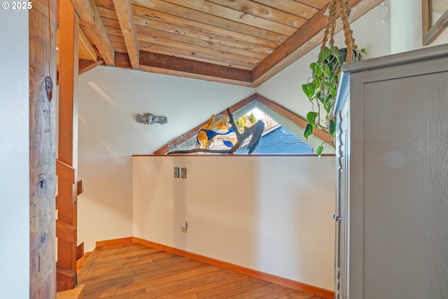 interior space featuring vaulted ceiling with beams, wooden ceiling, and light hardwood / wood-style floors