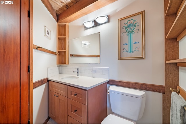 bathroom featuring toilet, tasteful backsplash, wood ceiling, vanity, and beamed ceiling