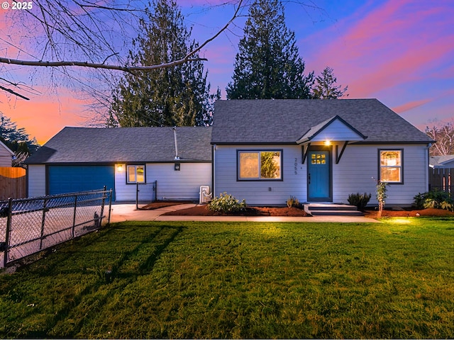 single story home featuring a yard and a garage