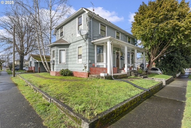 view of front of house featuring covered porch and a front lawn