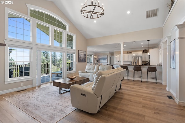 217 Deal Canyon Rd, La Grande, OR 97850 - living room featuring a chandelier, light wood-style flooring, high vaulted ceiling, baseboards, and recessed lighting