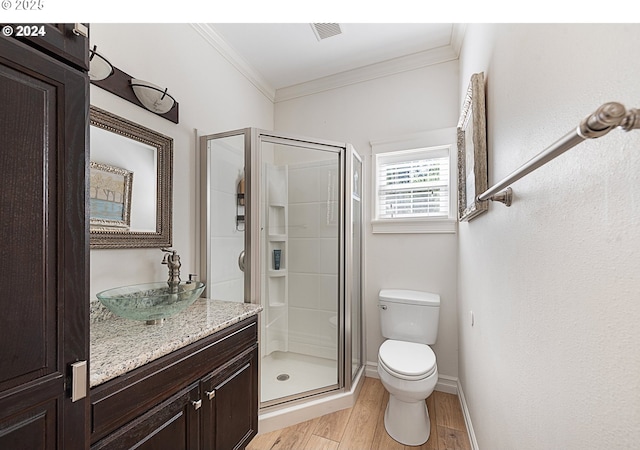 217 Deal Canyon Rd, La Grande, OR 97850 - full bathroom featuring crown molding, toilet, a shower stall, wood finished floors, and vanity