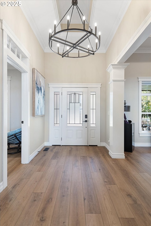 217 Deal Canyon Rd, La Grande, OR 97850 - entryway featuring a chandelier, hardwood / wood-style flooring, ornamental molding, baseboards, and a towering ceiling