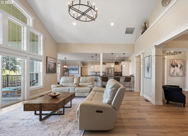 217 Deal Canyon Rd, La Grande, OR 97850 - living room with high vaulted ceiling, a chandelier, decorative columns, light wood finished floors, and recessed lighting