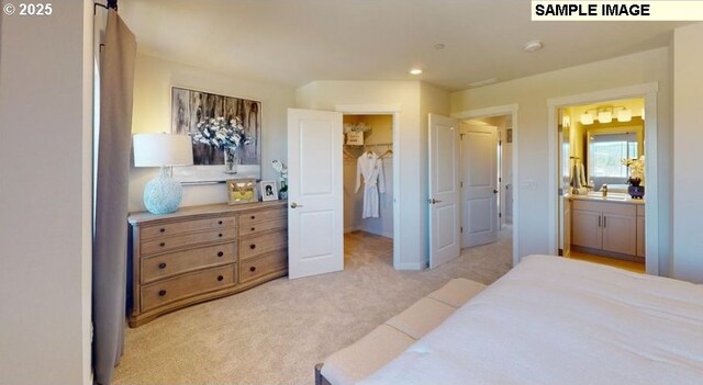 7510 NW Elise Ave, Portland, OR 97229 - bedroom featuring a walk in closet, light carpet, a closet, ensuite bathroom, and recessed lighting
