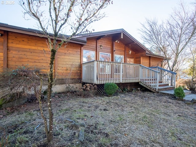 view of side of property featuring a wooden deck