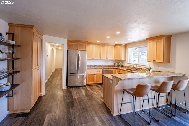2250 Jeppesen Acres Rd, Eugene, OR 97401 - kitchen featuring appliances with stainless steel finishes, light brown cabinetry, a sink, a peninsula, and dark wood-type flooring