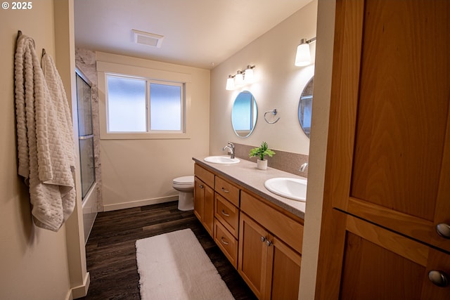 2250 Jeppesen Acres Rd, Eugene, OR 97401 - bathroom featuring double vanity, wood finished floors, baseboards, toilet, and shower / bath combination with glass door