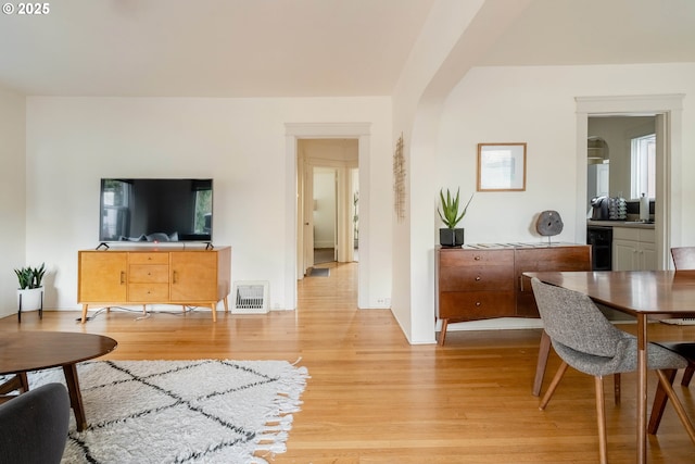 living room with wine cooler and light hardwood / wood-style flooring