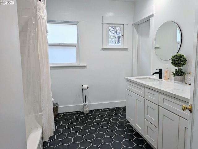 bathroom with shower / tub combo and vanity