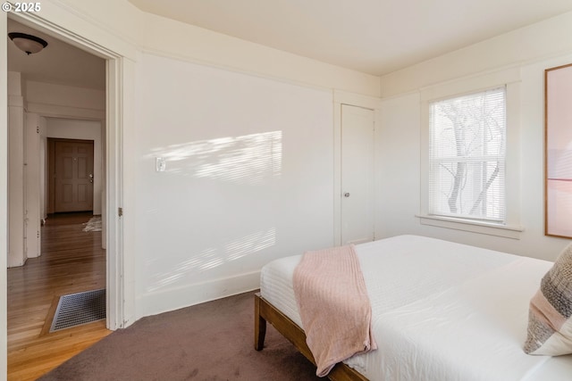 bedroom with wood-type flooring