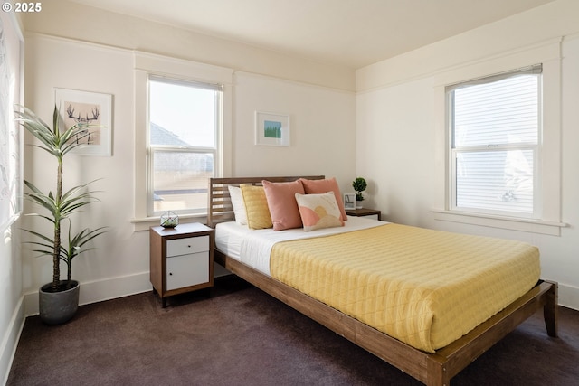 bedroom with dark colored carpet