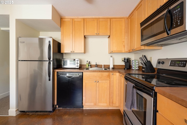 kitchen featuring light brown cabinetry, sink, and appliances with stainless steel finishes