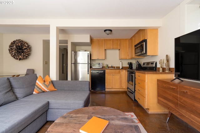 kitchen featuring light brown cabinets and stainless steel appliances