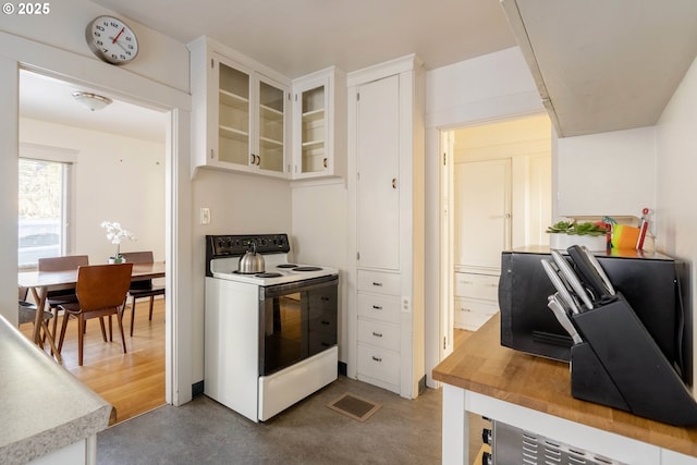 kitchen with white cabinetry and white electric range