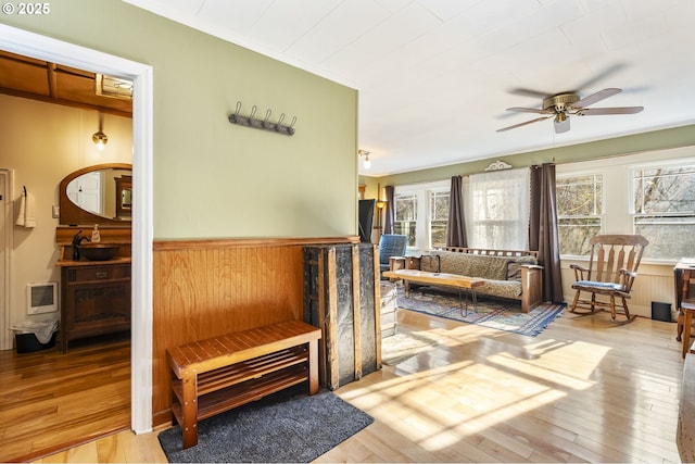 hallway with light hardwood / wood-style floors and wooden walls