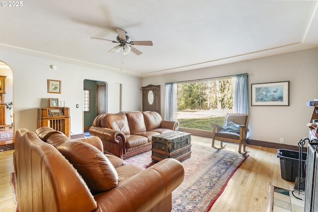 living room with ceiling fan and light wood-type flooring