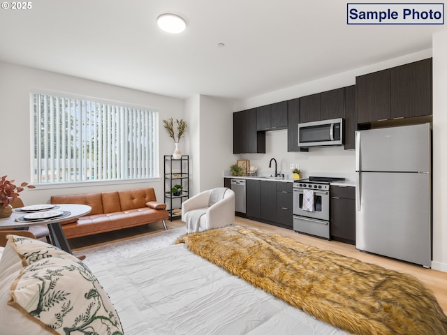 10985 E Burnside St Unit 3, Portland, OR 97216 - kitchen with light countertops, appliances with stainless steel finishes, and a sink