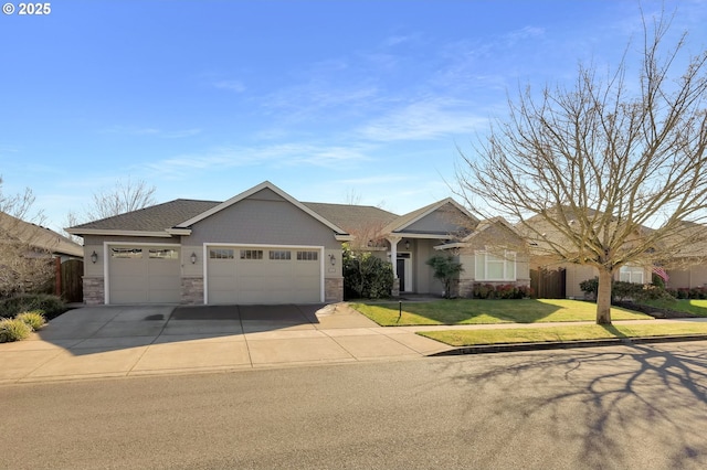 single story home with a front lawn, stone siding, driveway, and an attached garage